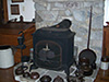 This is the 'before' photo.  The clients had an old metal woodstove that needed to be replaced.  They like the stonework on the wall and didn't want it removed.  They also did not want to have to move the flue location.  It was important to them that the new masonry heater not be taller than the stone 'mantel' on the wall.  Equally important, they did not want the heater occupying any more space than what was reserved for this old stove.  Limits like these impose harsh design restrictions, but that's where I started!