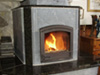 This is a completely custom soapstone masonry heater.  Every piece of soapstone and granite was meticulously cut and shaped specifically for this project.  The inside (inner life) construction is shown in exquisite detail in my book, Masonry Heaters: Designing, Building, and Living with a Piece of the Sun.