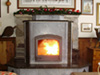 The new masonry heater is like an additional piece of furniture in the room.  Though it takes up no more floor space than the original metal stove, the heater adds a more comfortable warmth as well as additional seating to this cozy living area.