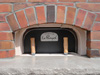 Though the door looks small, the oven here can hold about seven generous boules of artisan bread or several 10 inch pizzas.  Imagine cooking crisp pizzas in about 3 minutes; that's about 60 pizzas per hour!  That's a party! The simple brick arch over the door blends well with the generous 10 inch limestone shelf.